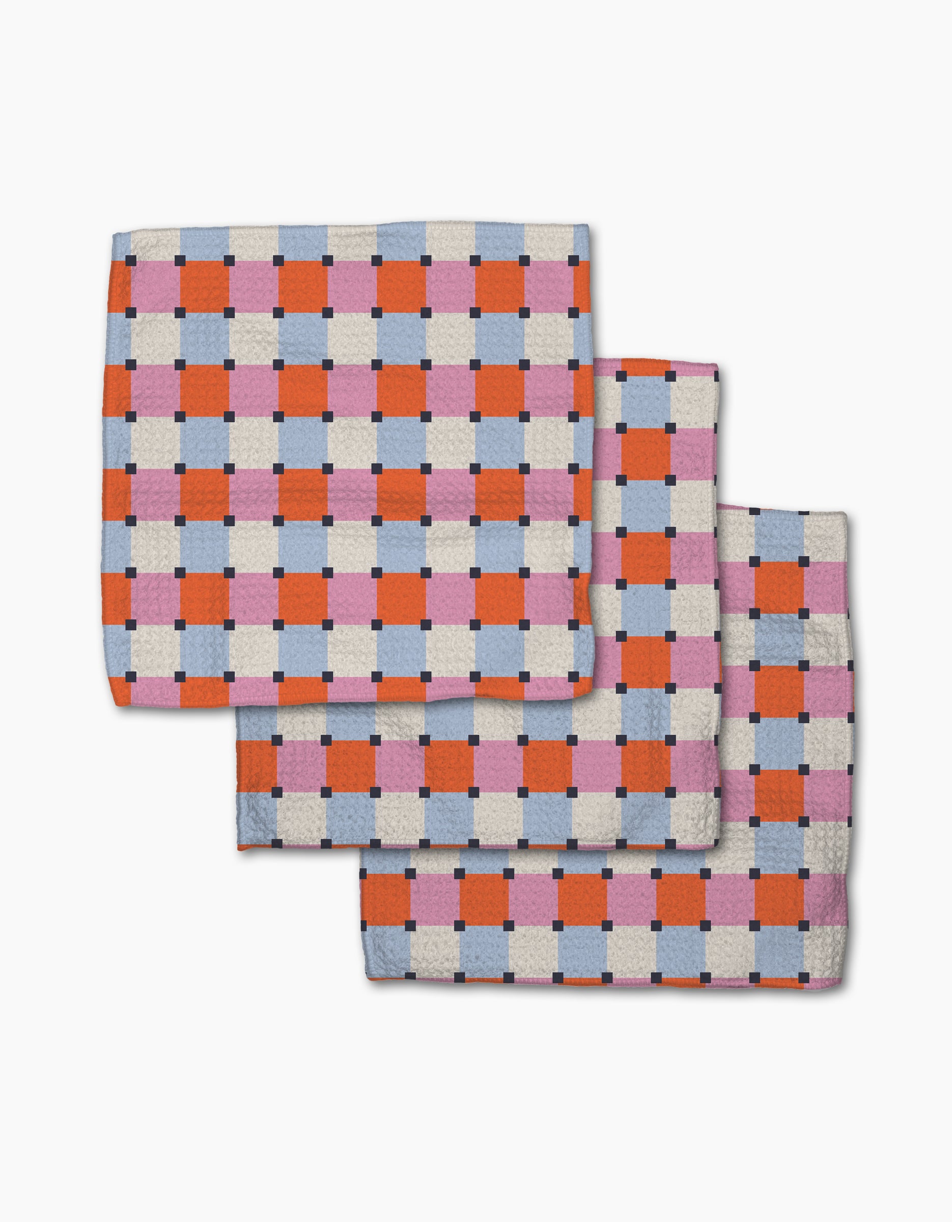 The Claire Iglesias Color Block Grid dishcloth set features three folded, checkered blankets in red, pink, blue, and white. Overlapping on a white background, they highlight fast-drying and super-absorbent qualities—perfect for any kitchen.