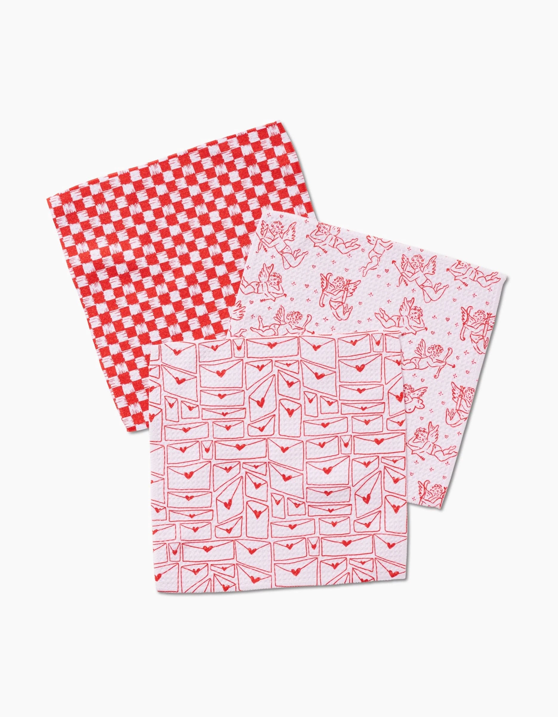 Three Cupids My Valentine dishcloths by Kayla Ann, made from recycled materials, are arranged on a white background: one checkered, one with envelopes, and one featuring a whimsical cat and bird pattern.
