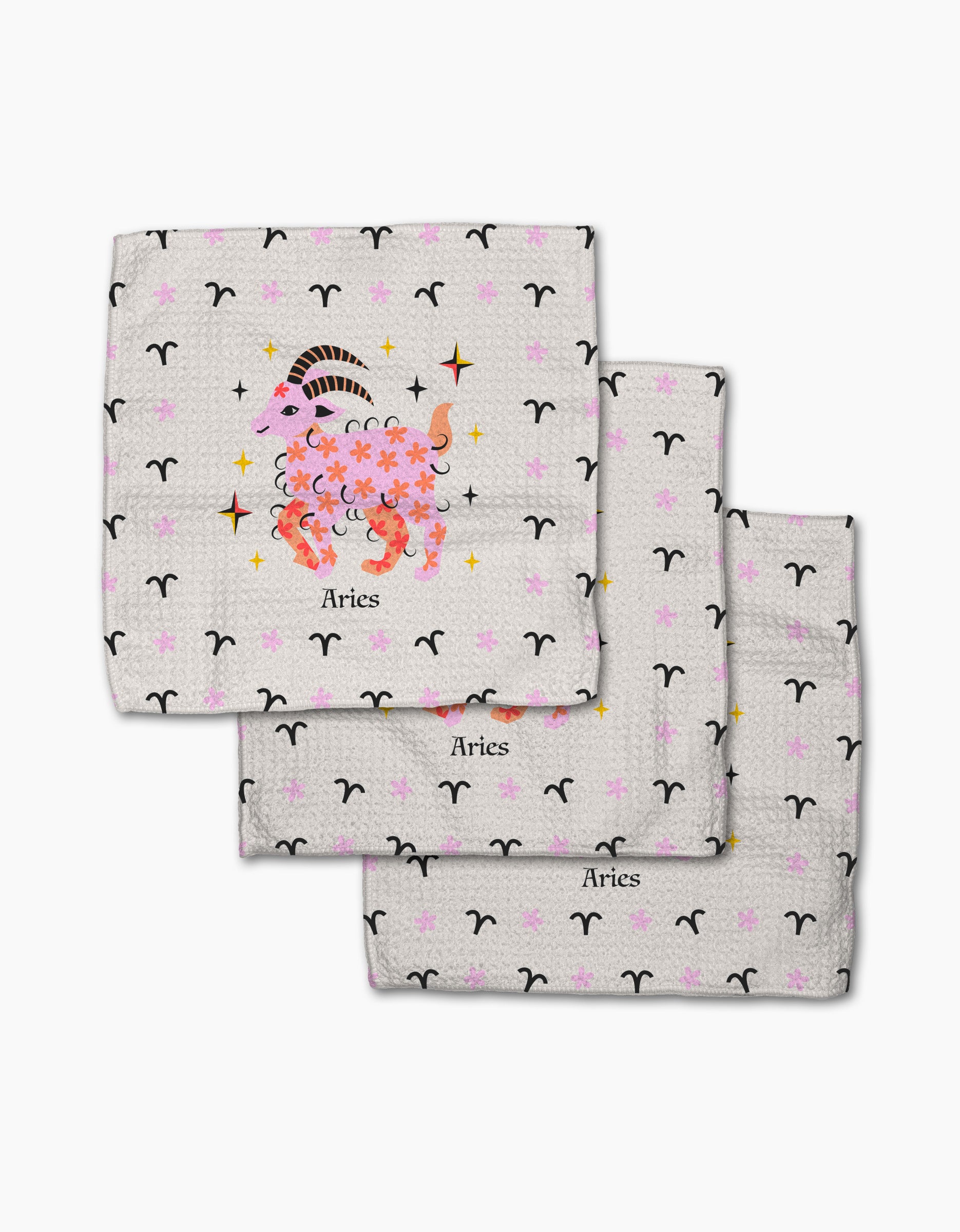 Set of three white cloth napkins by Heather Zhou, called "Daring Aries," made from recycled materials. Features black Aries symbols, gold stars, a pink-orange central ram with flowers, and "Aries" printed below.