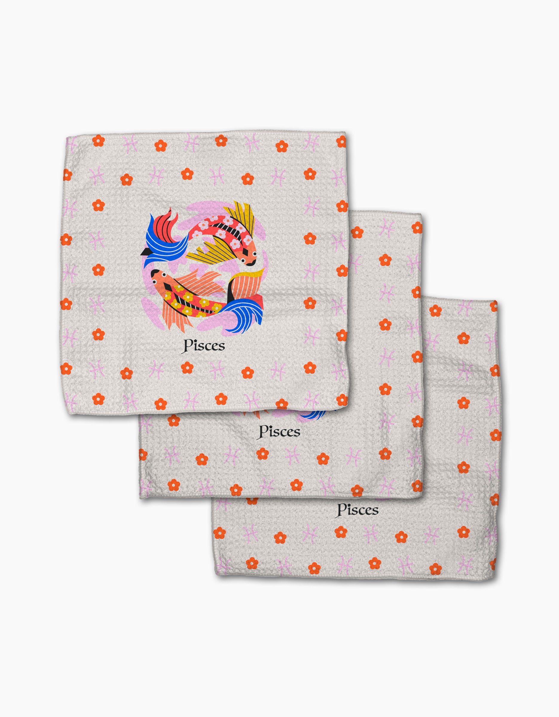 The Dreamy Pisces set by Heather Zhou includes three white napkins with pink and orange floral patterns, each featuring colorful fish illustrations and "Pisces" below—an absorbent, charming addition to any kitchen.
