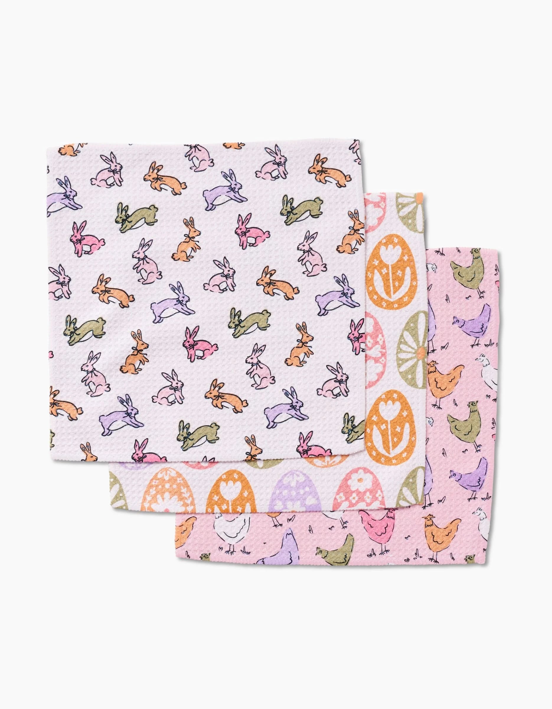 The Kayla Ann Easter Eggs set includes three pastel Geoweave dishcloths with playful spring designs: multicolored bunnies, eggs and hearts, and chicks and hens on a pink background.