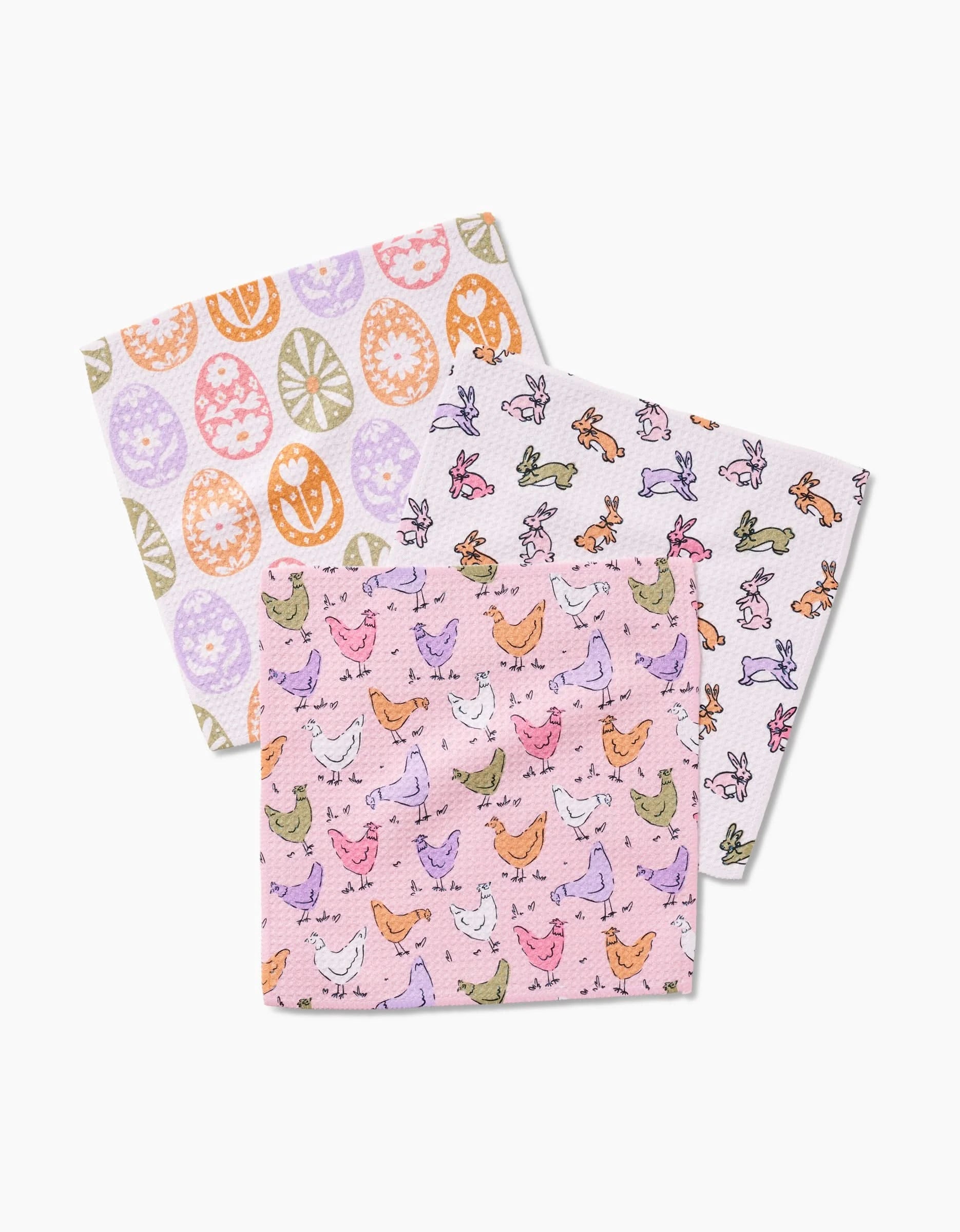 Kayla Ann’s “Easter Eggs” set features three square dishcloths—colorful eggs, bunnies, and chickens on pink—crafted from recycled materials and displayed against a white background.