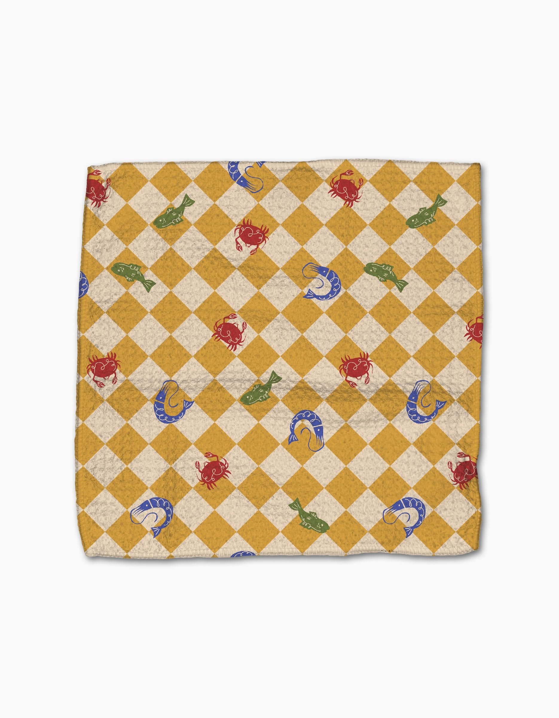 The El Mar Abierto dishcloth from Geometry features a yellow and white diamond checkered pattern, accented with red crabs, green fish, and blue seashells on a super-absorbent square design.