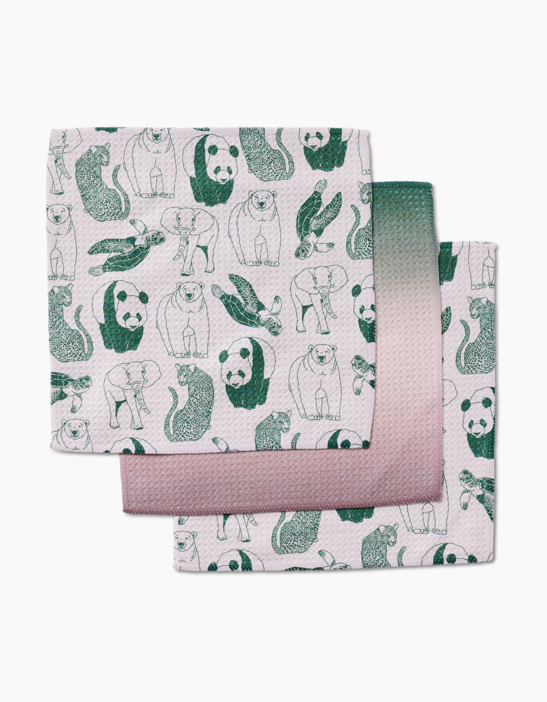 GEOMETRY’s Endangered set includes three recycled dishcloths, each with green line drawings of bears, pandas, and otters on a white background highlighted by green and pink gradient edges.