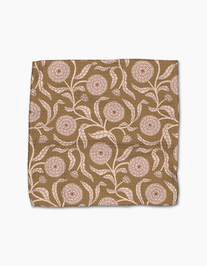 The Teri the Butter Falling Flowers dishcloth is a square brown fabric with cream and red floral and leaf patterns, shown flat on a white background.