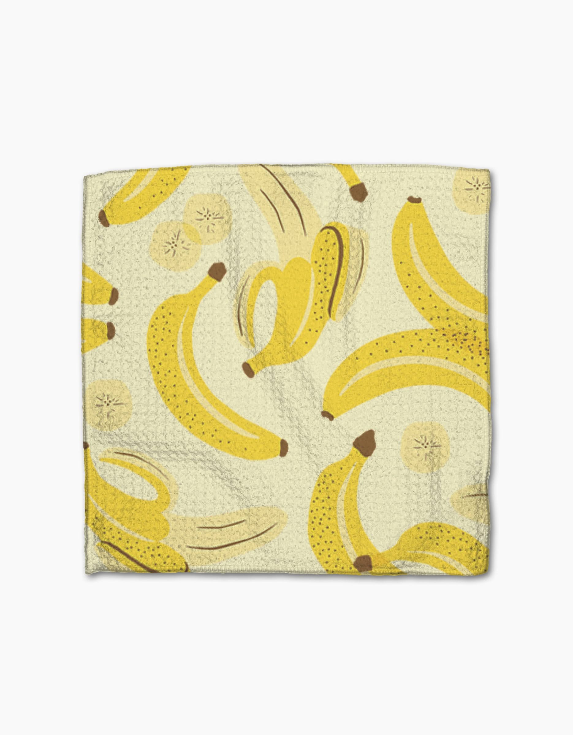The Geometry Favorite Fruit napkin is made from Geoweave fabric and features a yellow banana print with whole, peeled bananas, and sliced rounds on a light background.