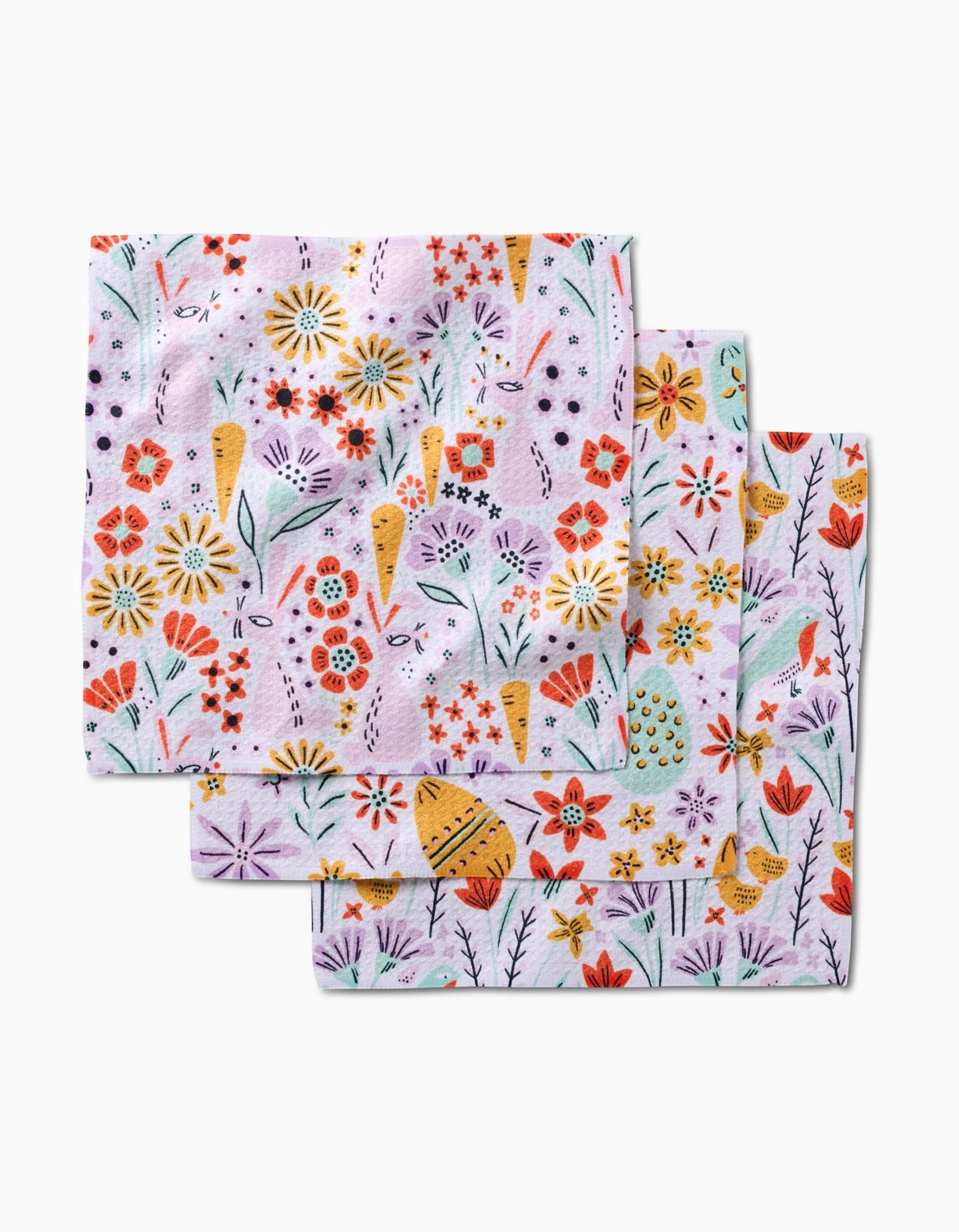 Three Floppsie Lilith and Thaddeus napkins by Amy MacCready, featuring a vibrant floral and butterfly pattern on light purple—crafted from recycled materials for an eco-friendly touch.