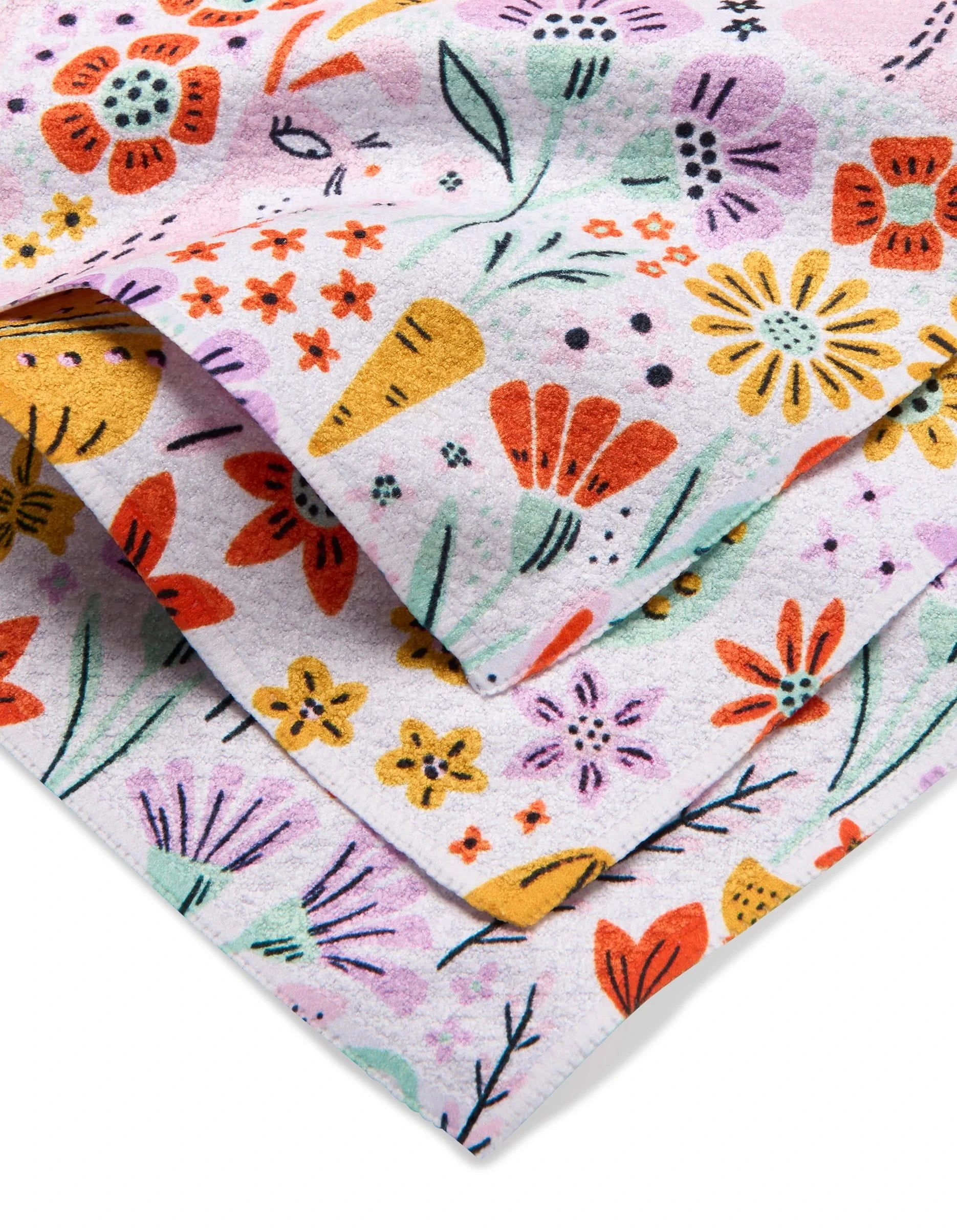 Floppsie Lilith and Thaddeus dishcloth set by Amy MacCready features folded white towels with a vibrant floral pattern in red, yellow, orange, and purple. Made from recycled materials for an eco-friendly, cheerful touch.