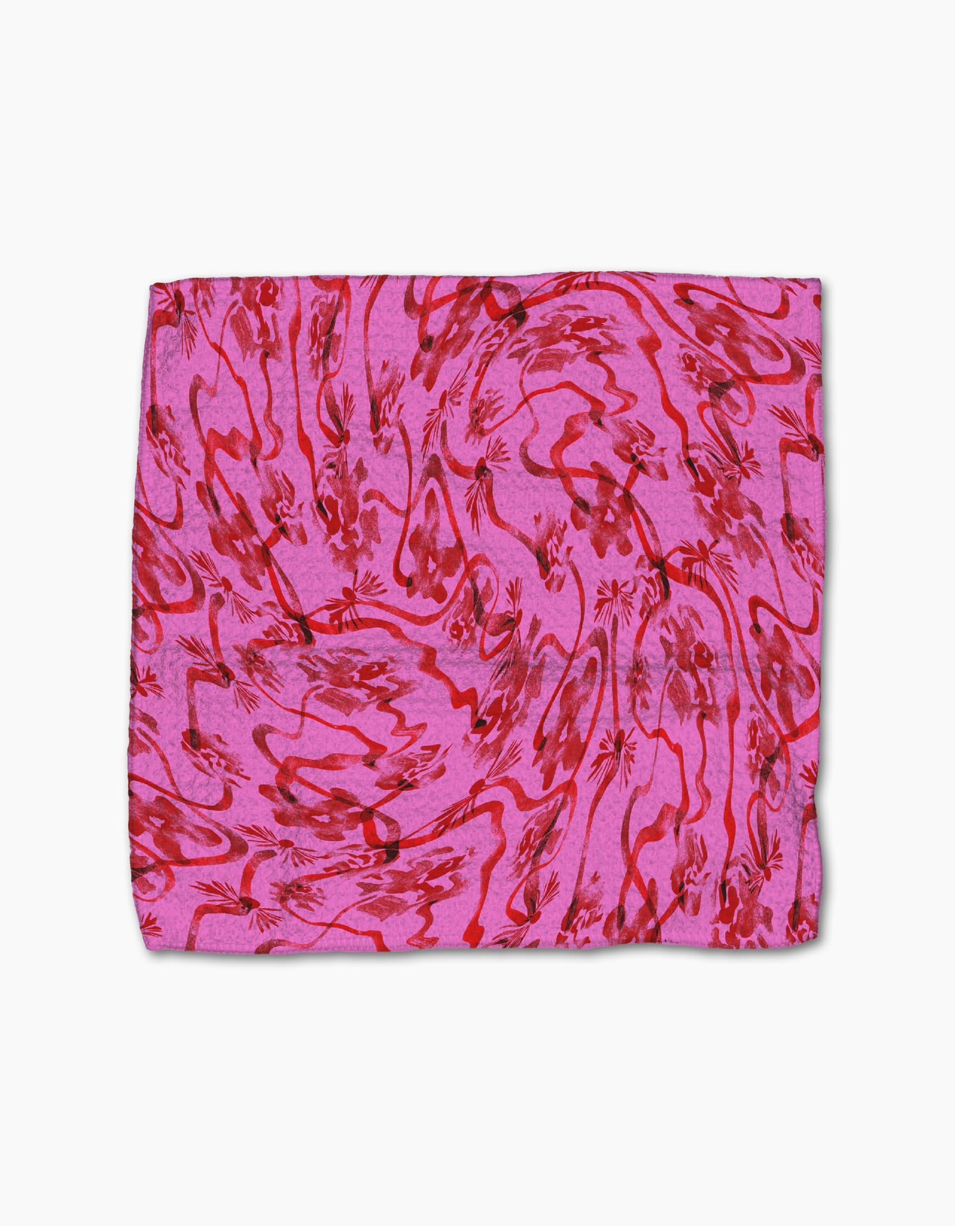 The Geometry Floral Swirls Pink Geoweave cloth features a pink rectangle with red abstract floral and wavy patterns, displayed flat on white—ideal as a decorative dishcloth or stylish kitchen towel.