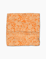 The Florence fabric square by Katie OShea features an orange base with a cream floral and leaf pattern, intricately designed and crafted from recycled materials, shown laid flat on a white background.