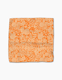 The Florence fabric square by Katie OShea features an orange base with a cream floral and leaf pattern, intricately designed and crafted from recycled materials, shown laid flat on a white background.