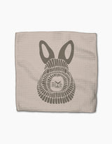 Forest Animals by Rosa Kichline: A beige textured cloth made from recycled materials, featuring a stylized gray bunny face with large ears and geometric fur, set against a white background.