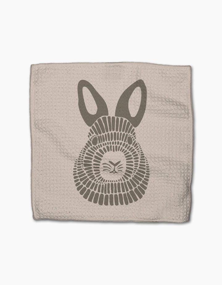 Forest Animals by Rosa Kichline: A beige textured cloth made from recycled materials, featuring a stylized gray bunny face with large ears and geometric fur, set against a white background.