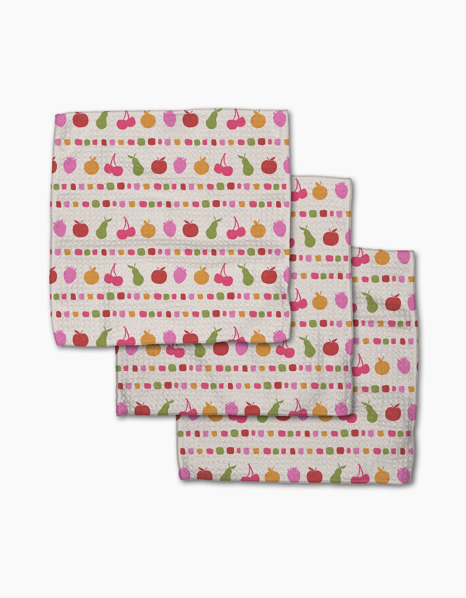 Geometry’s “Fruits At The Party” set includes three Geoweave napkins featuring cherries, apples, pears, and dots in colorful horizontal stripes on a light background.