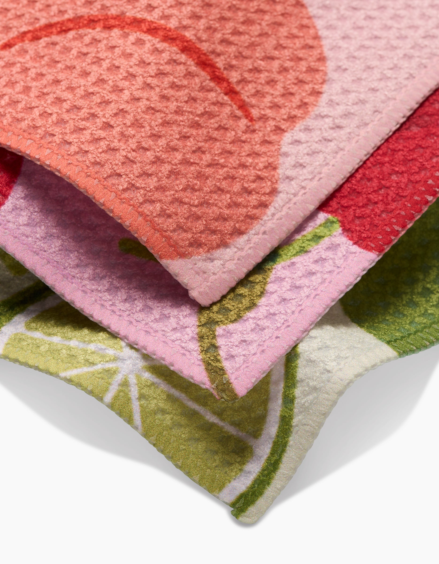 Fruit Fun by GEOMETRY features three recycled Geoweave dishcloths with colorful fruit patterns—red and pink cherries plus a green lime slice—layered together for eye-catching style and textured, effective cleaning.
