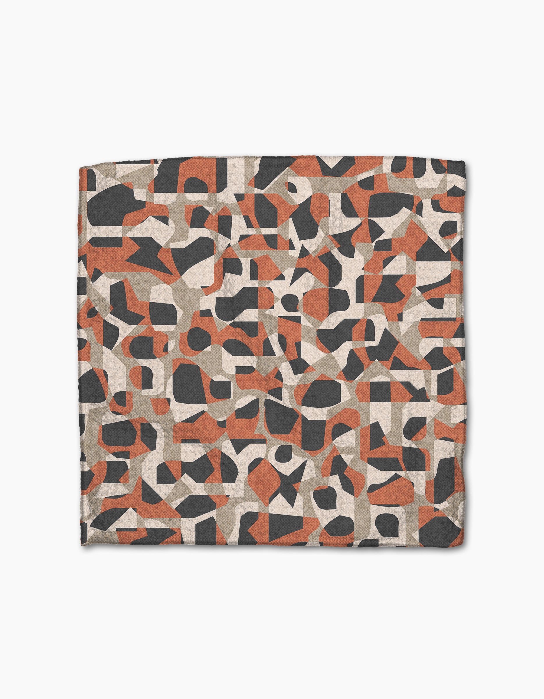The Geometric Leopard dishcloth set by Kris Ruff features a modern, artistic design with irregular black, reddish-brown, and beige shapes on a light background, crafted from recycled materials.