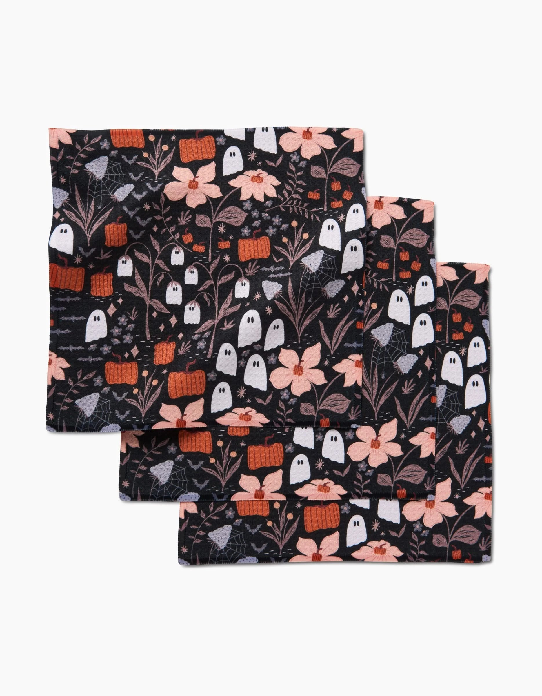 Three black cloth napkins—Ghosts In The Midnight Garden by Charlie Rowan Designs—feature playful Halloween patterns and are an eco-friendly, recycled dishcloth set.