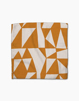 The Golden Angles towel by Lisa Nelson features a white and orange-brown geometric triangle pattern on textured fabric, crafted from recycled materials for super-absorbency and eco-friendly appeal.