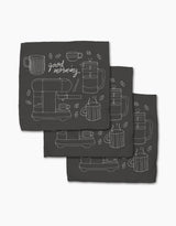 The Rosa Kichline Good Morning Coffee set includes three black recycled cloth napkins with minimalist white line art of coffee cups, a French press, beans, and good morning cursive in a repeating pattern.