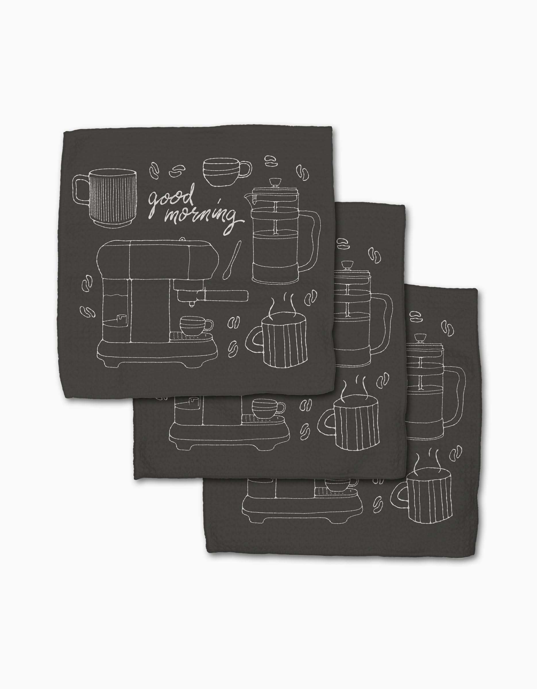 The Rosa Kichline Good Morning Coffee set includes three black recycled cloth napkins with minimalist white line art of coffee cups, a French press, beans, and good morning cursive in a repeating pattern.