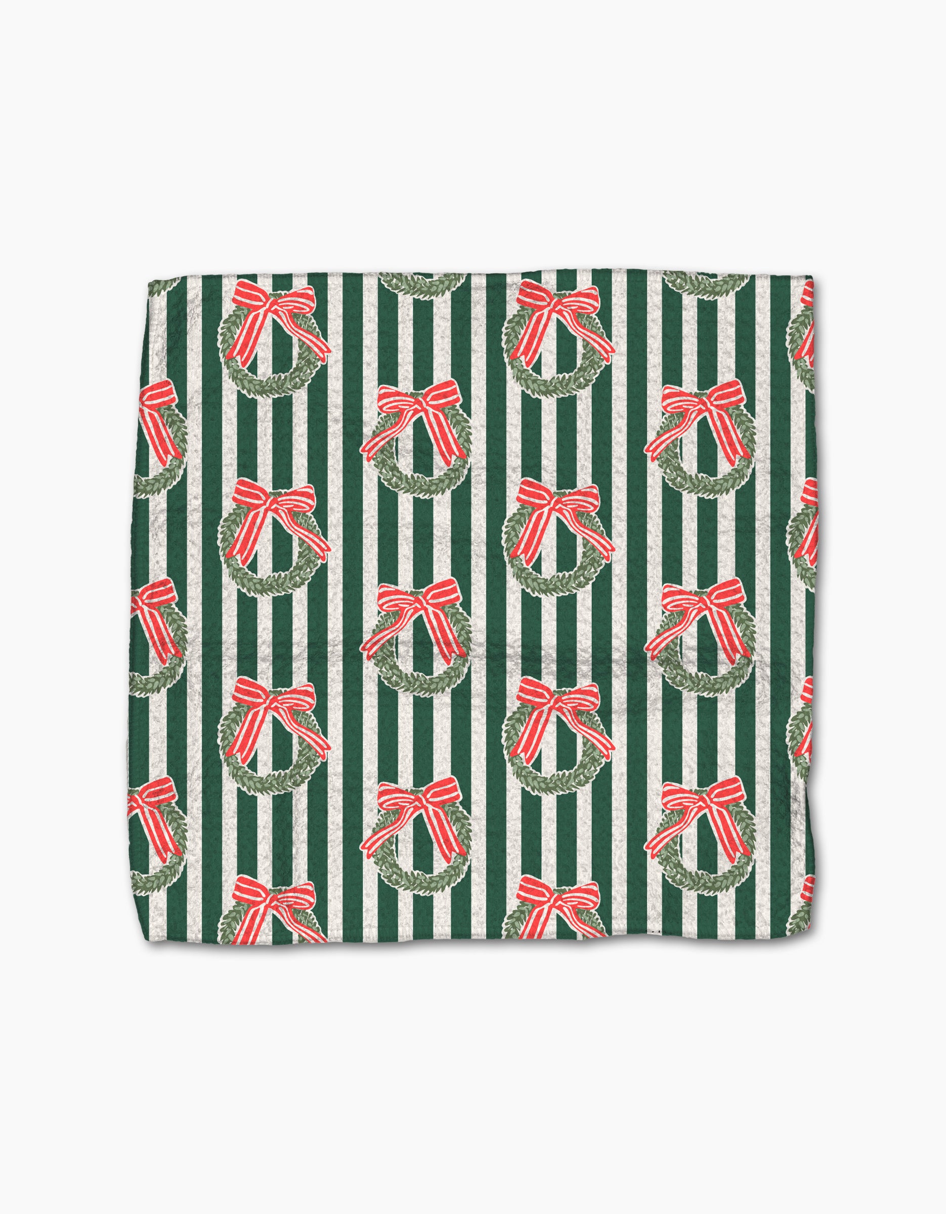 Cozy up this holiday with the Green Wreaths blanket by Charlie Rowan Designs—a folded throw featuring festive green and white stripes and repeating green wreaths with red bows, perfect to pair with your favorite absorbent dishcloths.