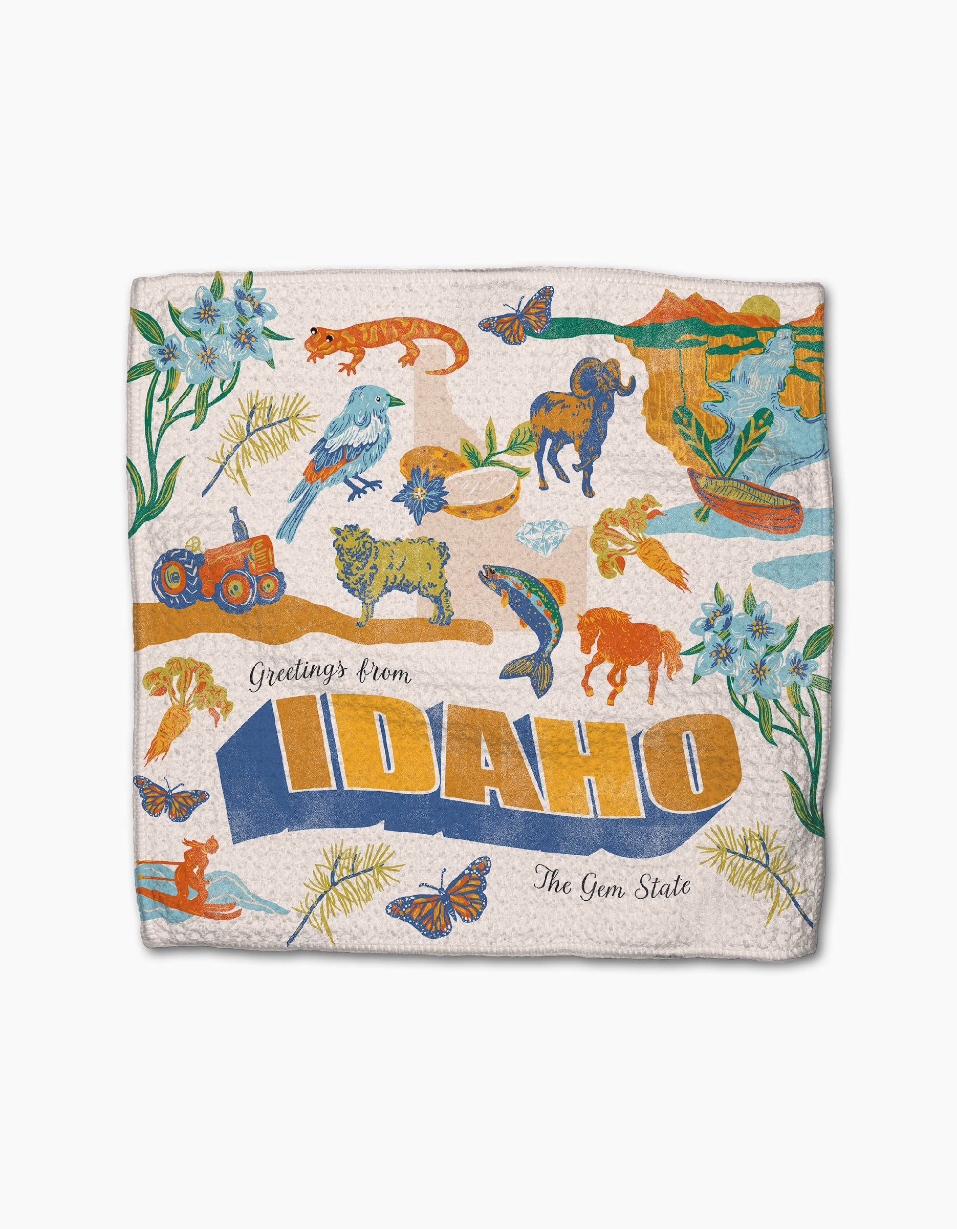 The Geometry Greetings From Idaho design showcases vibrant wildlife, flowers, a tractor, mountains, and butterflies with "The Gem State" on a textured background—ideal for super-absorbent dishtowels or a bright dishcloth set.