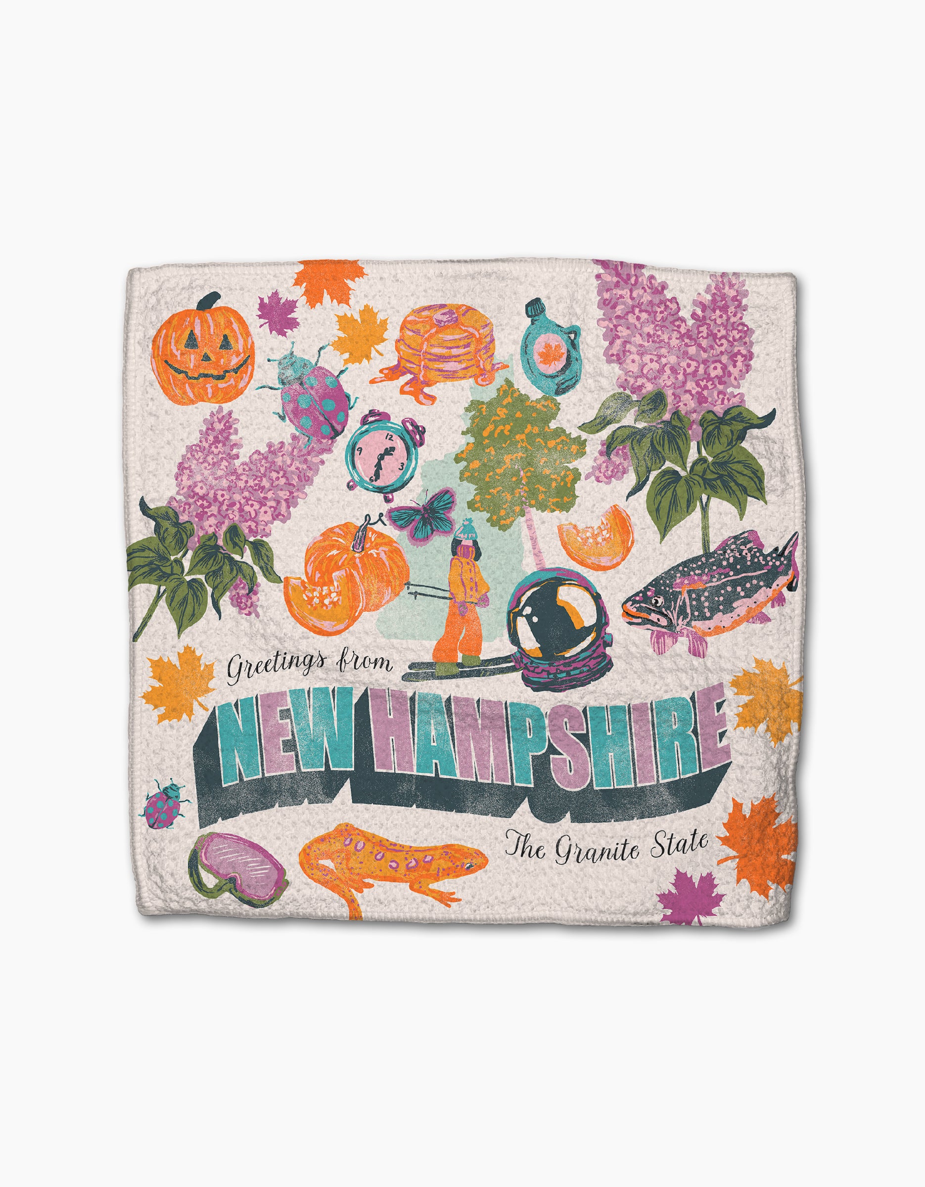The Geometry "Greetings From New Hampshire" towel features bold retro lettering and colorful motifs like pumpkins, lilacs, pancakes, maple leaves, a fish, and more from their super-absorbent dishtowel collection.