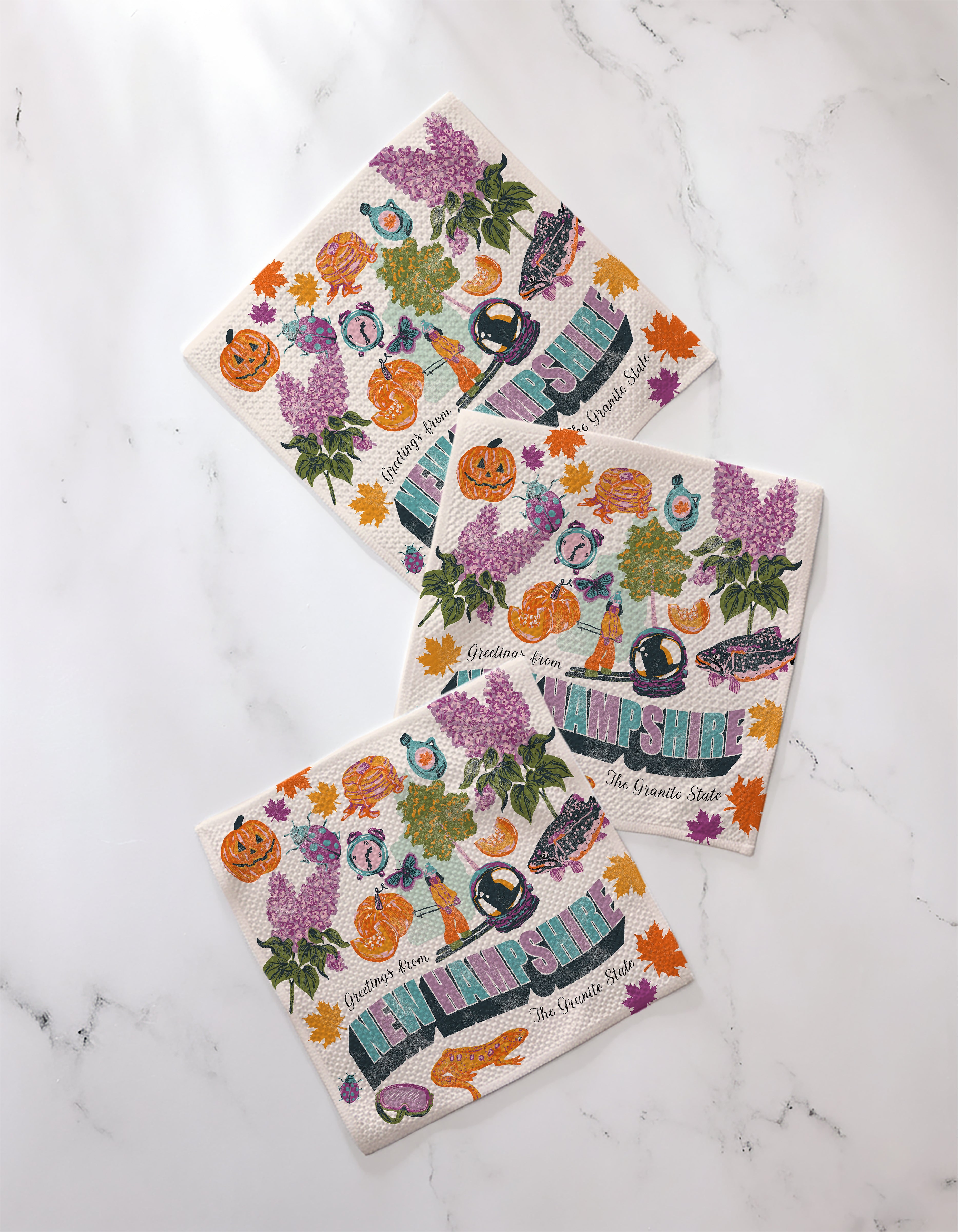 Geometry's "Greetings From New Hampshire" napkins are made from recycled materials, each showcasing a unique design.