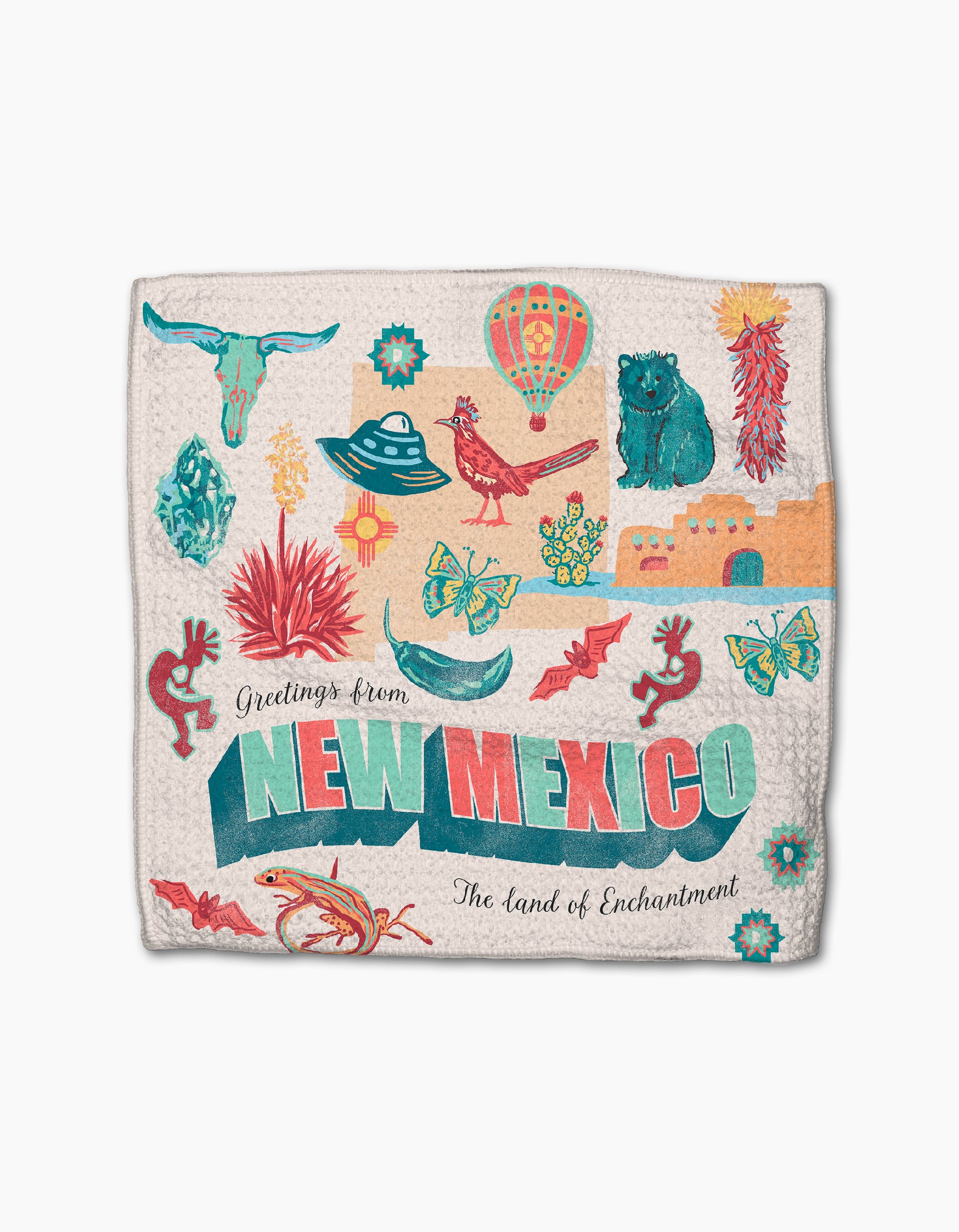 The Geometry "Greetings From New Mexico" dishtowel is super-absorbent and features colorful illustrations of state icons—UFO, hot air balloon, chili peppers, cactus, cow skull, lizard, pueblo—with “Greetings from NEW MEXICO: The Land of Enchantment” text.