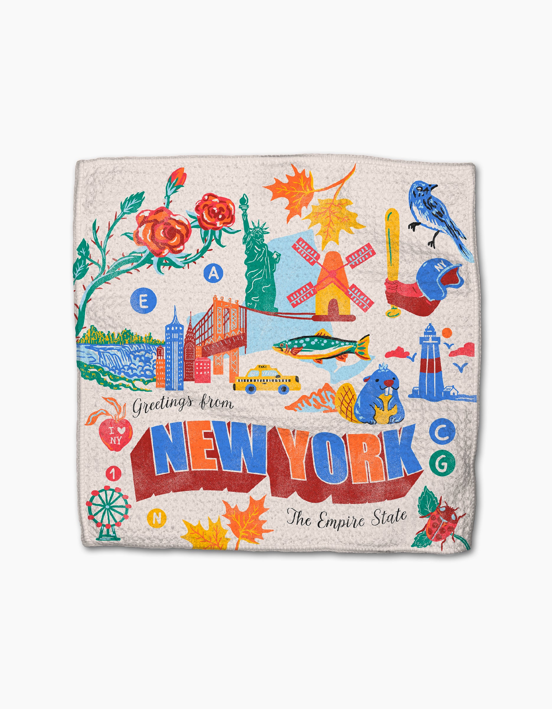 The Geometry "Greetings From New York" kitchen towel features vibrant prints of landmarks, autumn leaves, a rose, a bluebird, a frog, a lighthouse, and other iconic New York symbols.