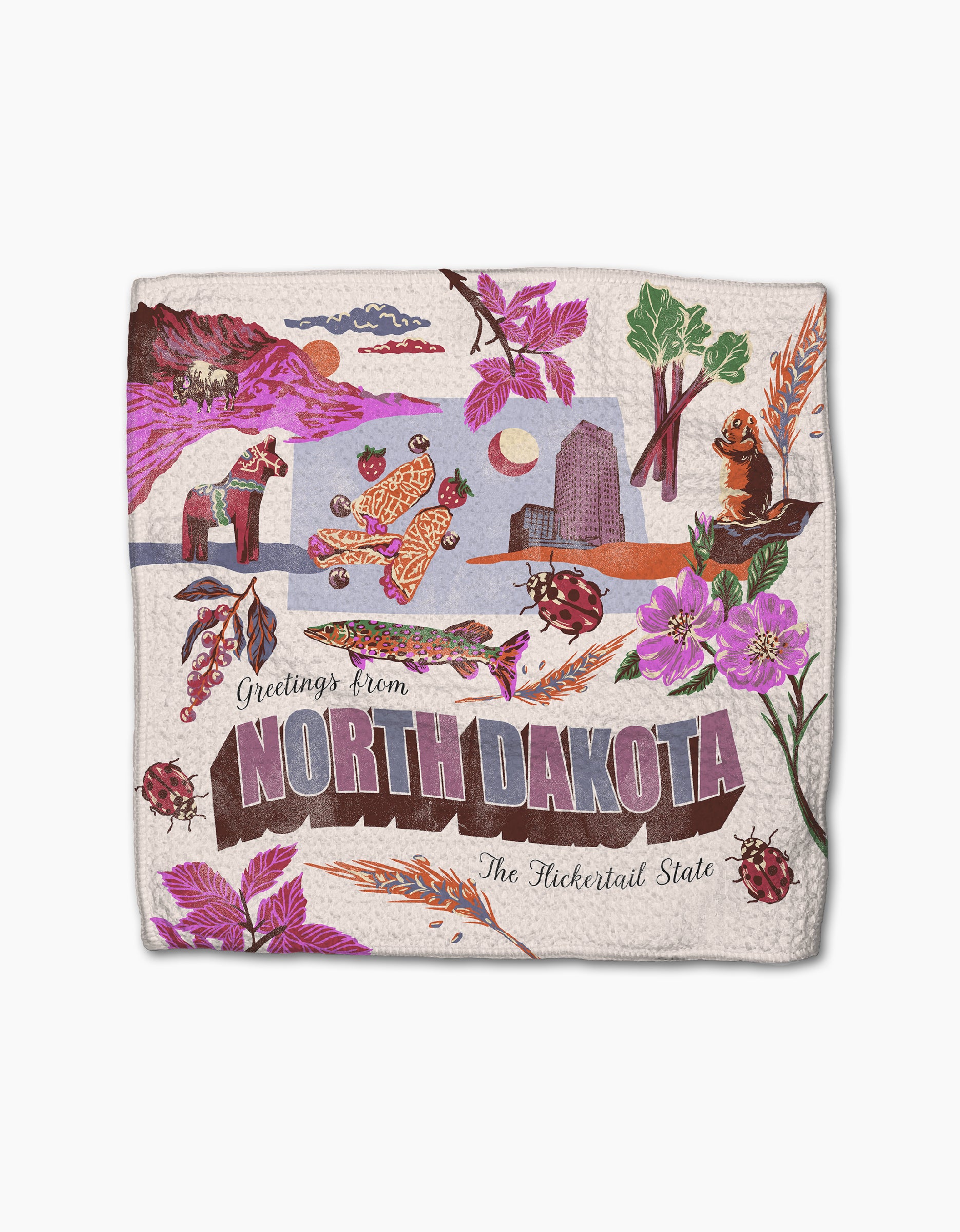 Geometry’s “Greetings From North Dakota” towel features recycled materials and vibrant designs with flowers, a bison, prairie dogs, ladybugs, trees, and landscapes—super-absorbent and perfect for your kitchen.