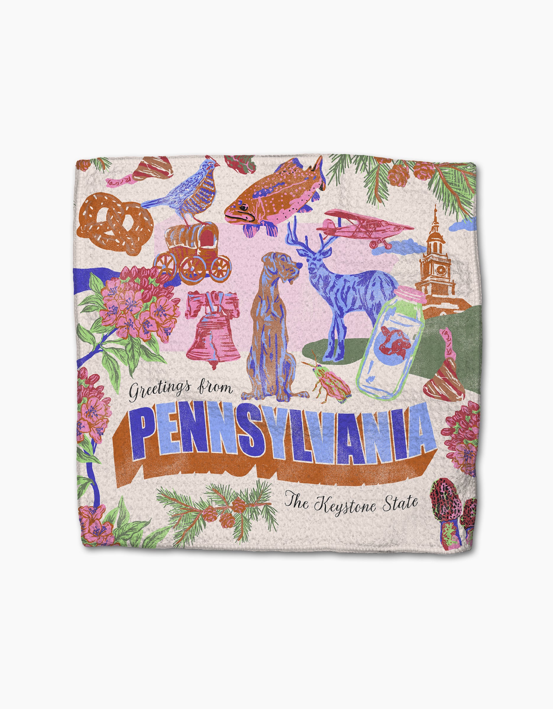 The Geometry “Greetings From Pennsylvania” dishtowel displays colorful illustrations of state symbols—dog, deer, pretzels, fish, Liberty Bell, flowers—and the text “Greetings from PENNSYLVANIA The Keystone State.”.
