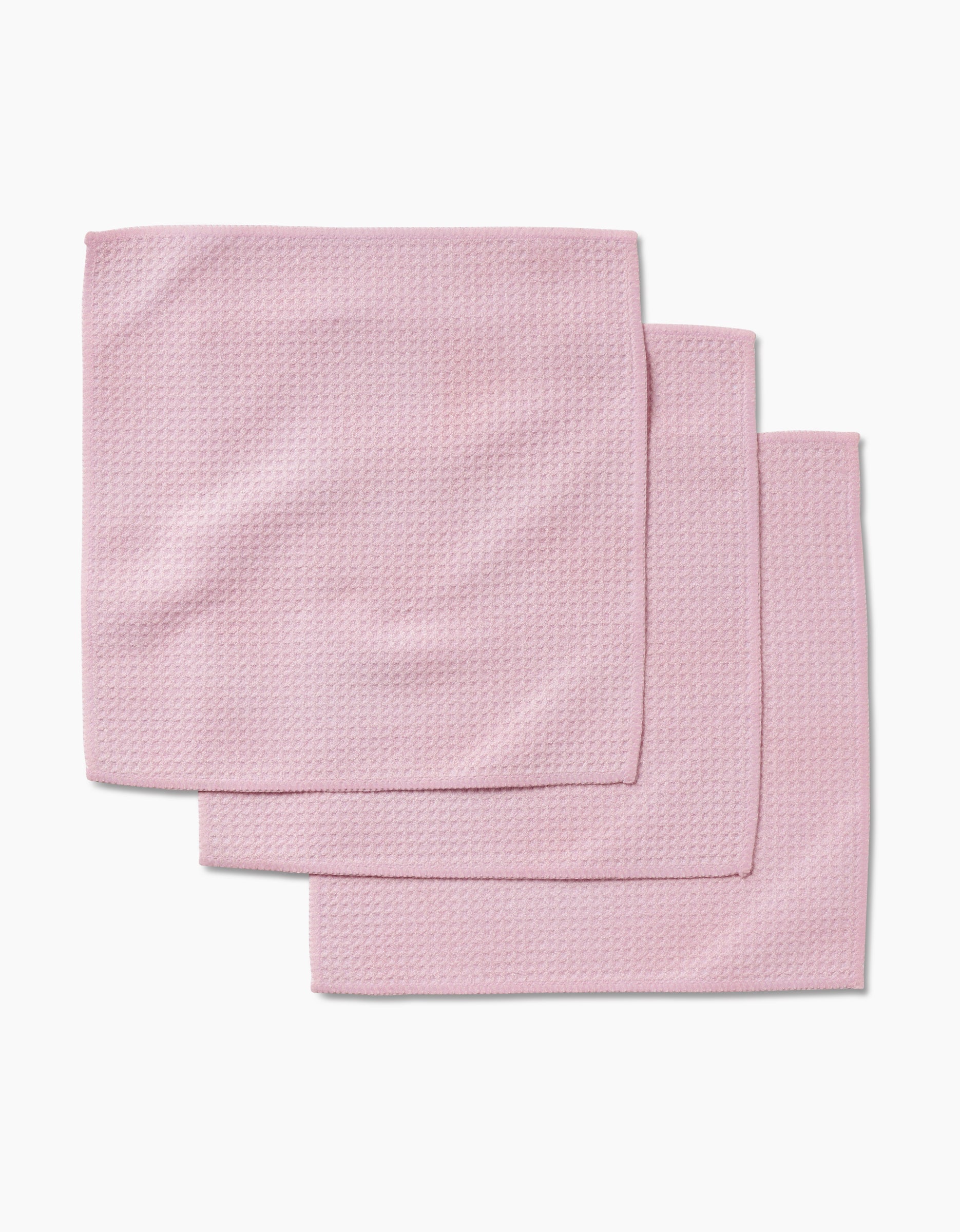 Three folded Harper Pink washcloths, made from Geoweave fabric, are stacked in a slightly overlapping arrangement on a white background.