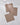 Three Hearth recycled dishcloths by Geometry, featuring a brown and white houndstooth pattern, are neatly arranged on a white marble surface, with two overlapping at the corners.