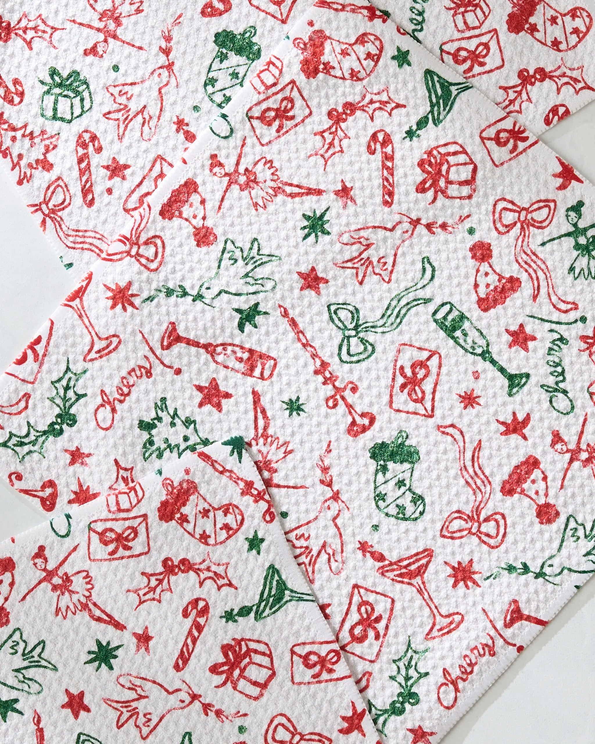 Geometry’s Holiday Doodles Multi paper towels feature festive red and green Christmas prints—holly, gifts, bows, and candy canes—in a cheerful repeating pattern, perfect for brightening your kitchen or pairing with an absorbent dishcloth set.