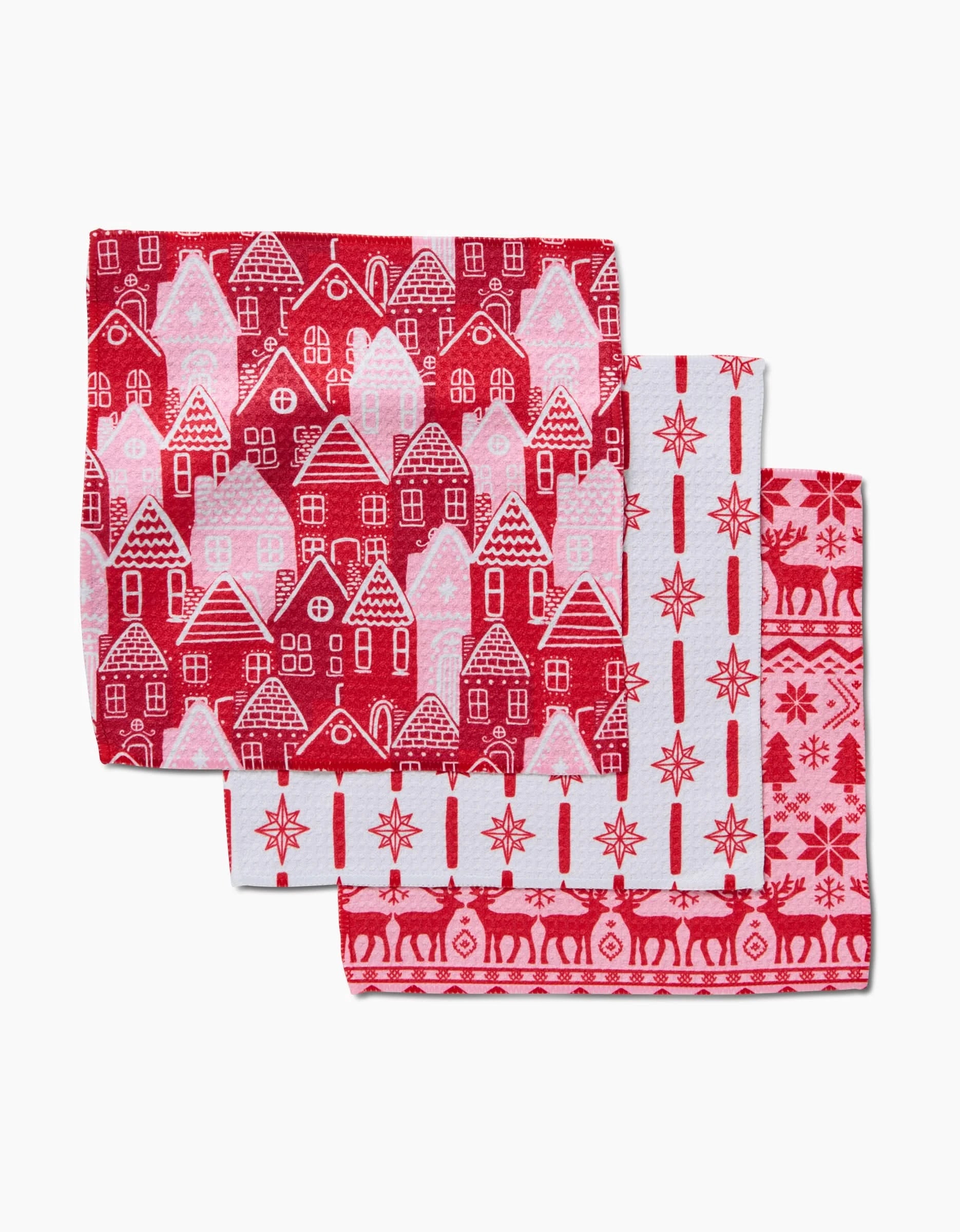 The Holidays set by Hufton Studio includes three festive kitchen towels featuring houses, stars, and reindeer in red and white patterns, crafted from ultra-absorbent Geoweave fabric for style and function.