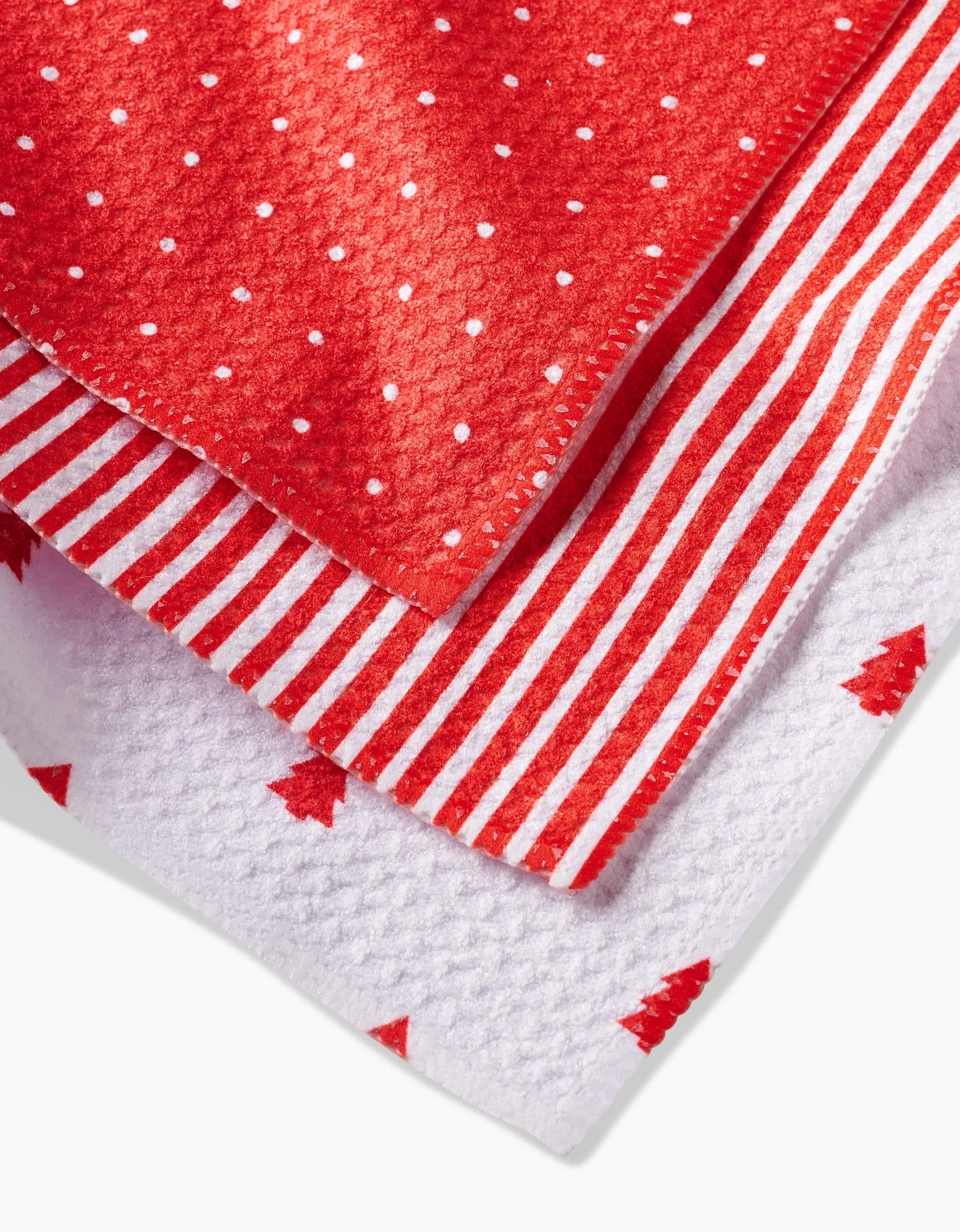 Kailee Wright Jolly set: three folded super-absorbent dishcloths in festive red and white—one polka dot, one striped, and one with Christmas trees.