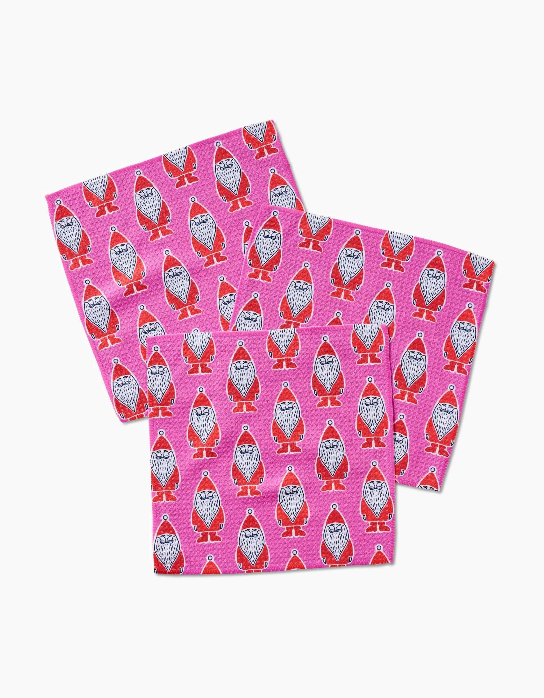 The Amy MacCready Klass set includes three pink dishcloths made from recycled materials, each featuring cartoon penguins with red bow ties and boots in a playful, overlapping pattern on a white background.