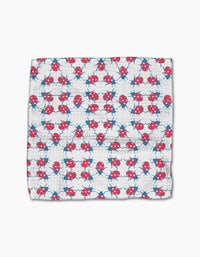 The Ladybug Dance dishcloth by Second Nature Studio features a white Geoweave fabric with rows of playful red and blue ladybugs, crafted from recycled materials for an eco-friendly touch.