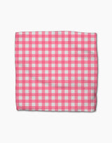 A rectangular Lemon Pop cloth from Ashley Celena’s super-absorbent dishcloth set, displaying a pink and white checkered gingham pattern, is laid flat on a white background.