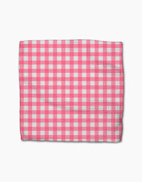 A rectangular Lemon Pop cloth from Ashley Celena’s super-absorbent dishcloth set, displaying a pink and white checkered gingham pattern, is laid flat on a white background.