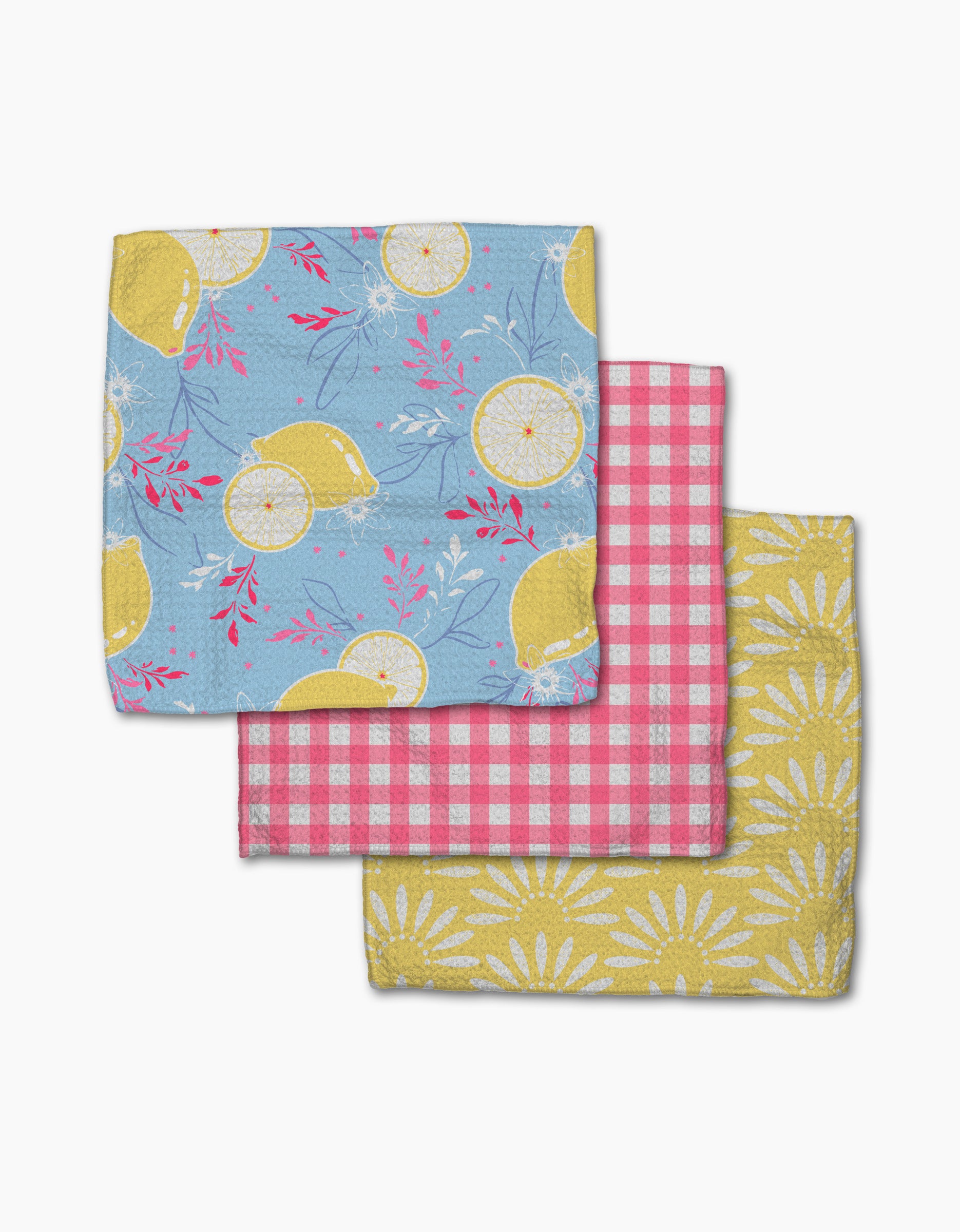 Ashley Celena’s Lemon Pop dishcloth set includes three folded napkins: blue with yellow lemons, pink and white gingham, and yellow daisy prints—each super-absorbent for everyday kitchen use.