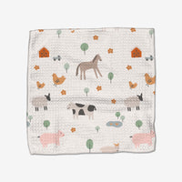 The Coit Creative Light Farm Animals Geoweave dishcloth showcases horses, cows, pigs, sheep, chickens, barns, trees, flowers, and ponds in soft pastels. Made from recycled materials for an eco-friendly touch.