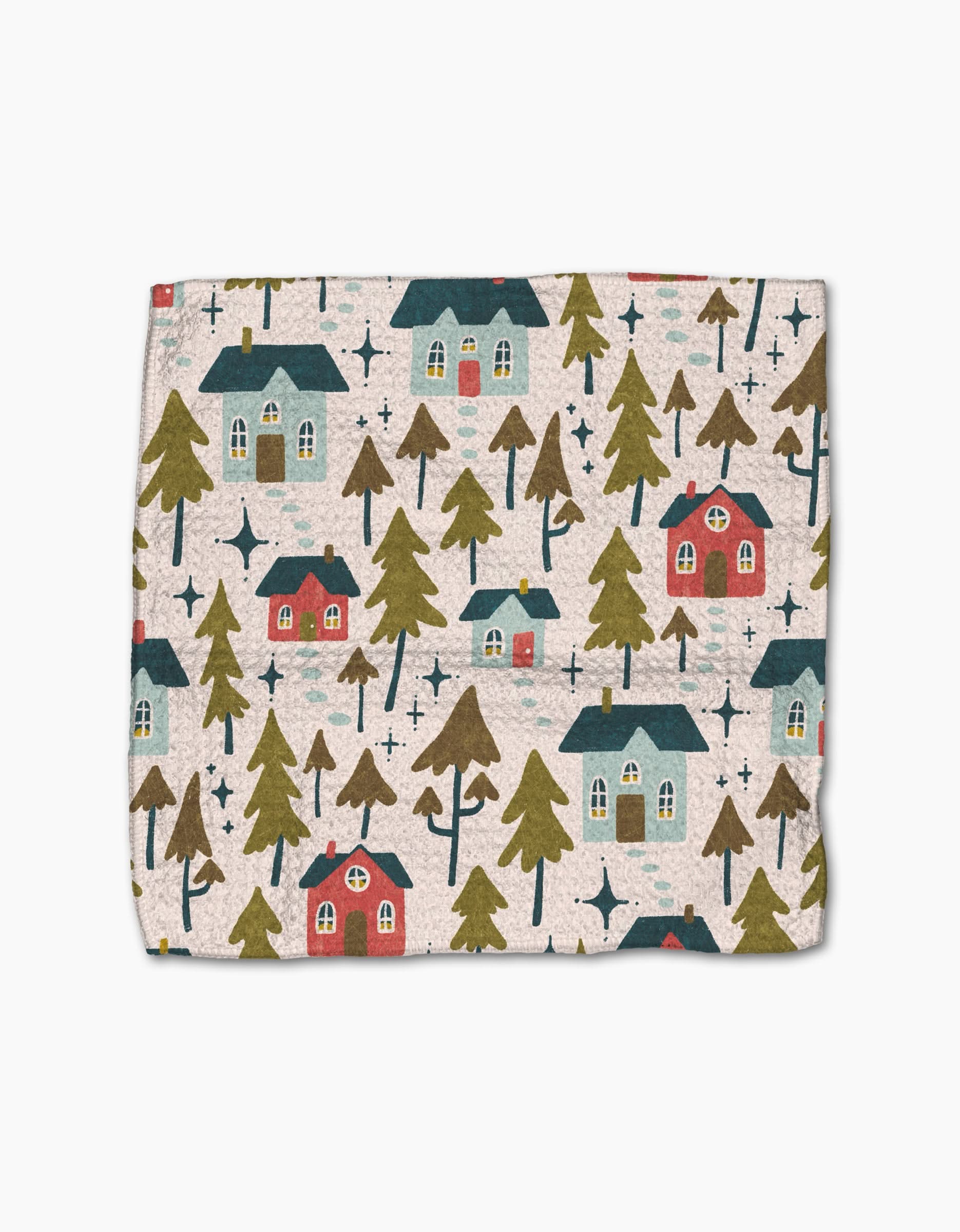 The Little Village blanket by Amy MacCready features soft Geoweave fabric with a whimsical pattern of red and blue houses, green trees, and navy stars on a light beige background.