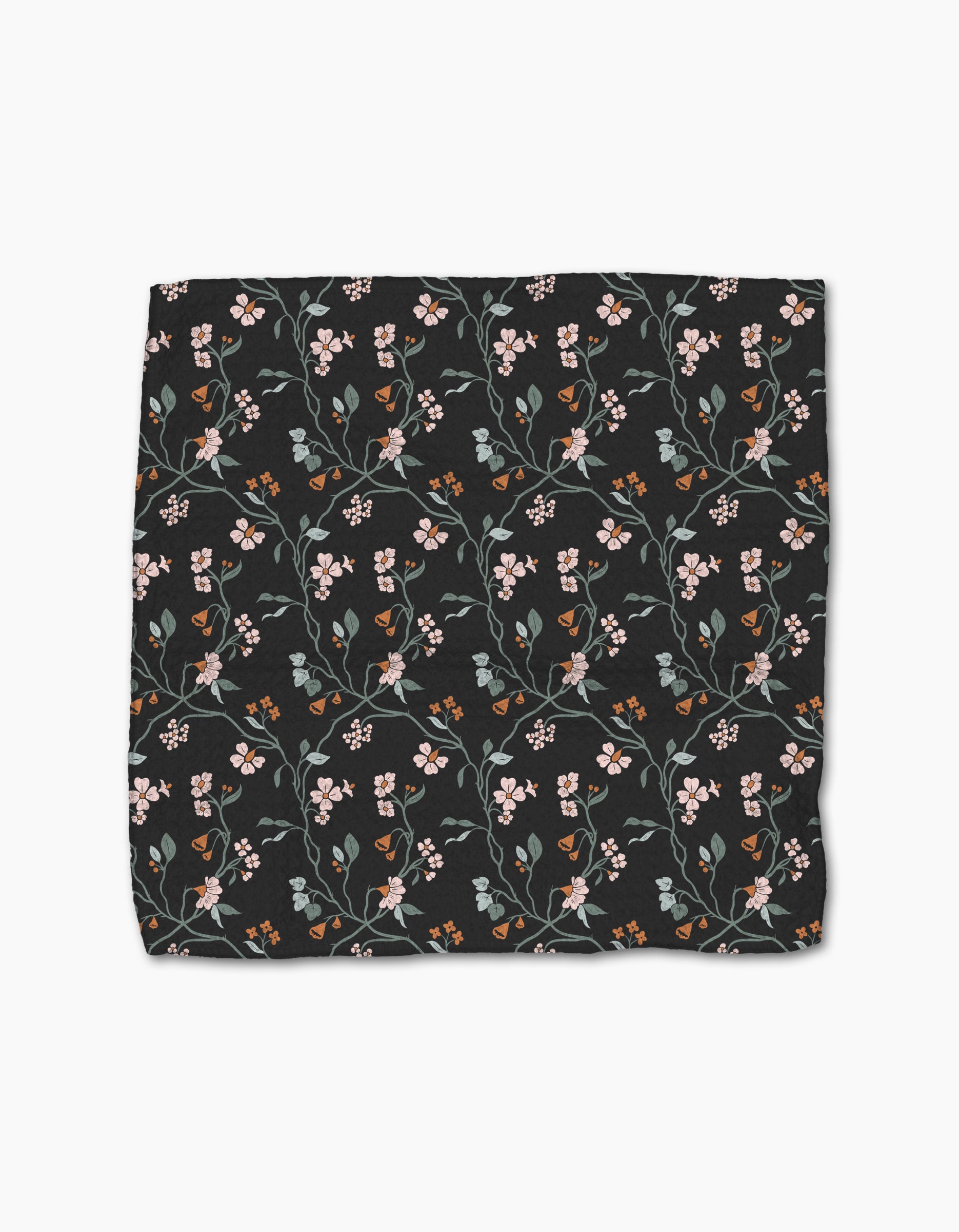 The Lunaria in Charcoal dishcloth set by Danelys Sidron features a super-absorbent, recycled black fabric with an all-over floral design of small pink, orange, and white flowers and green leaves.