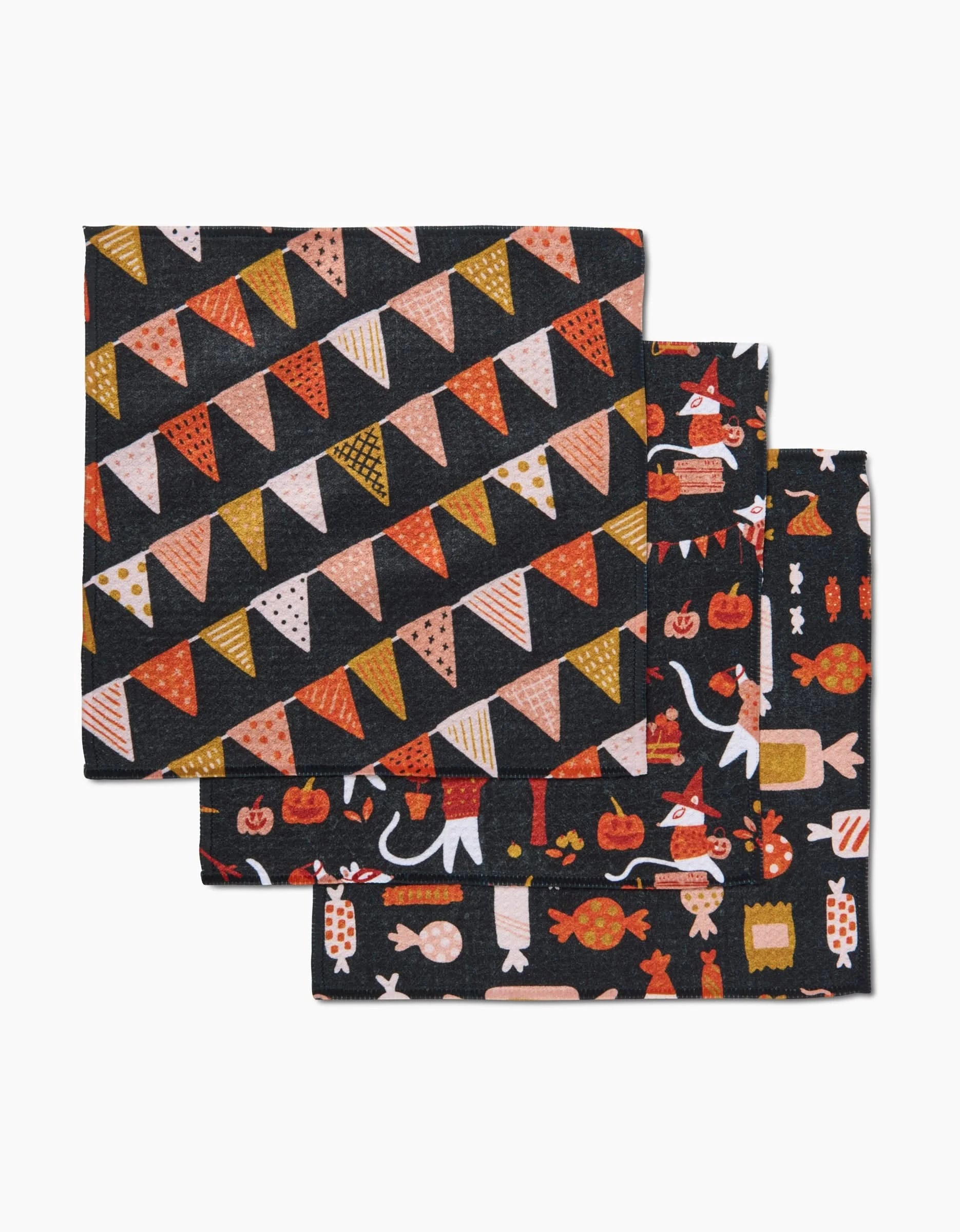Morticia Edwina And Morrigan by Amy MacCready: a set of two eco-friendly cloth napkins—one with colorful bunting flags, the other with Halloween icons on a dark background, perfect for festive décor.