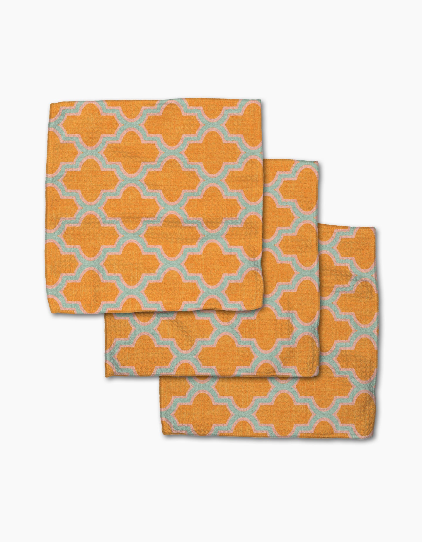 Three Mustard Ogee cloth napkins by Pascale Dilger, featuring a repeating light blue and white geometric pattern, arranged in an overlapping stack—stylish and eco-friendly, made from recycled materials.