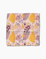 The Nature Sketch dishcloth set by Cottonflower Studio features a soft, rectangular design with a pink background and abstract yellow pears, purple leaves, white and orange branches. Modern, playful look crafted from recycled materials.