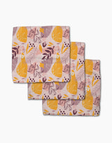 Nature Sketch cloth napkins by Cottonflower Studio—set of three, crafted from recycled materials—feature an abstract pink background with yellow pears, purple leaves, and scattered dots and shapes.