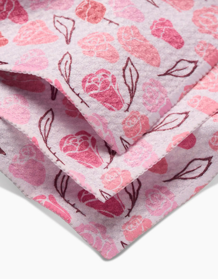 Close-up of the Elisabeth Wing Neutral Rose Dishcloth Set, featuring soft Geoweave fabric with a pink and red rose pattern on a light background—both stylish and practical for your kitchen.